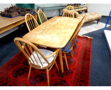 An Ercol elm and beech dining table, length 150 cm, together with a set of six high backed dining chairs, two carvers and fou