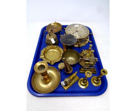 A tray containing assorted brass ware to include candlestick, miniature candlesticks and ornaments, goblet, sheep's wheel bat