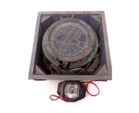 A military issue compass in a fitted box together with a further rubber cased pocket compass 