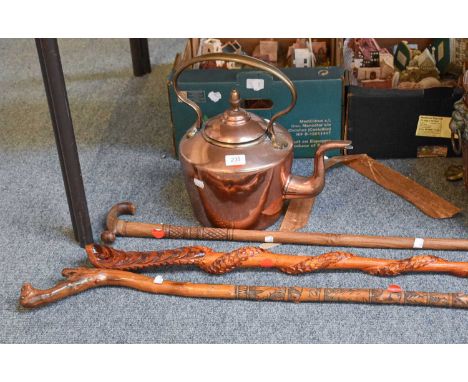 A 19th Century Copper Kettle, together with three carved walking sticks (4)