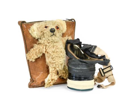 A Second World War Child's Gas Mask in "Teddy Bear" Case, the leather handbag case embossed with stylised seed pods, with zip