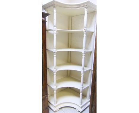 A five tier cream painted corner shelf unit