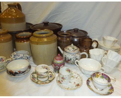 A collection of salt-glazed pots and storage jars, together with a stoneware flagon inscribed "F & T Horne Wine and Spirits M