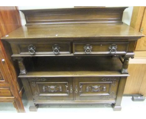 A mid 20th Century oak buffet in the circa 1900 Continental manner, the plain top above two drawers and a recess over two cup