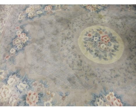 A Chinese superwash carpet, the central circular medallion in cream, pale green and mushroom on a mushroom floral decorated g