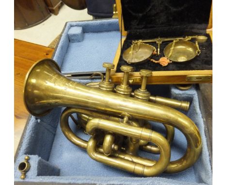 A Boosey & Co. Class A brass cornet housed in a black carrying case, together with a set of miniature scales housed in a wood