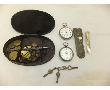 A box containing two white metal pocket watches, the white enamelled dials set with Roman numerals and decorated with floral 