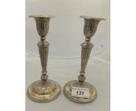 A pair of Edwardian silver candlesticks of fluted form (London, 1901) CONDITION REPORTS Both candlesticks are bent, the bases