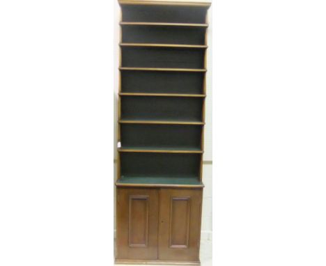 A mahogany seven shelf open bookcase with two cupboard doors below 