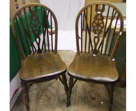 A set of four wheel and stick back dining chairs with stretchered bases and a green Lloyd Loom style bedside cabinet