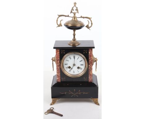 A 19th century French slate and red marble mantle clock, enamel dial, Roman numerals, with urn finial, twin side handles, rai