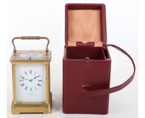 An early 20th century brass carriage clock, Jackman &amp; Son Bath, white enamel dial, Roman numerals, with leather carry cas