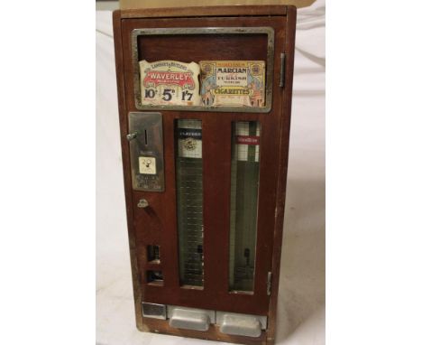 A Wills's mahogany single door cigarette vending machine with chromium plated mounts, 26" x 12½" (with key but seized)