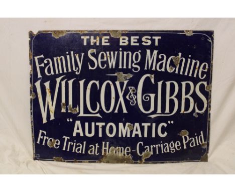 An enamel rectangular sewing machine sign "The Best Family Sewing Machine - Willcox &amp; Gibbs Automatic - Free Trial at Hom