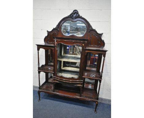 AN EARLY 20TH CENTURY MAHOGANY DISPLAY CABINET, carved foliate decoration, above a shaped bevelled mirror plate, above an arr