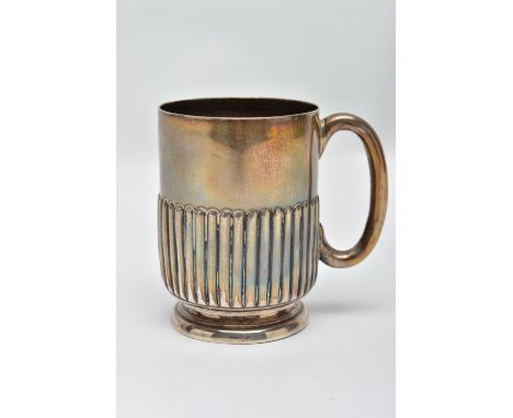A SILVER MUG, stop reeded pattern, raised on a round base, fitted with a curved handle, worn gilt, hallmarked 'Army &amp; Nav