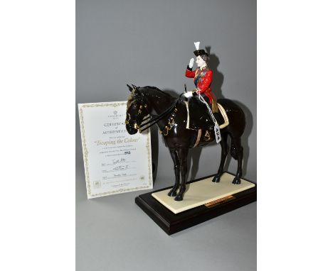 A COALPORT LIMITED EDITION 'TROOPING THE COLOUR' FIGURINE, depicting Her Majesty The Queen on horseback, supported in a separ