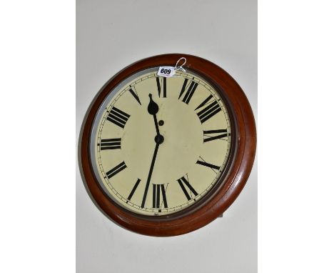 AN EARLY 20TH CENTURY CIRCULAR WALL CLOCK, 'train station style' with pendulum and key, Roman numerals on a cream face, diame
