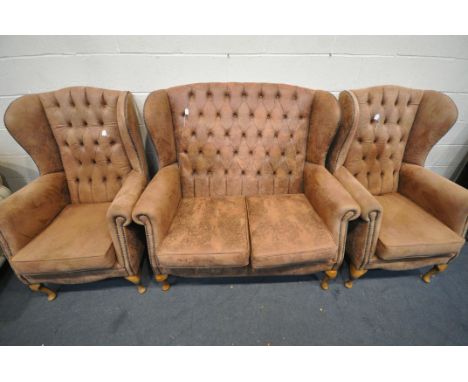 A FAUX LEATHER THREE PIECE LOUNCE SUITE, comprising a two seater sofa, and a pair of armchairs (condition - loose leg on sofa