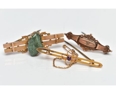 THREE LATE 19TH TO EARLY 20TH CENTURY GOLD BROOCHES, the first designed with a central circular amethyst within a wire floral