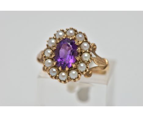 A 9CT GOLD AMETHYST AND SEED PEARL CLUSTER RING, the oval cut amethyst within claw setting to the seed pearl surround and tri