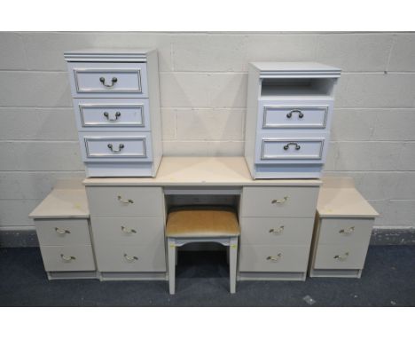 A CREAM FOUR PIECE BEDROOM SUITE, comprising a dressing table with six drawers, length 139cm x depth 42cm x height 75cm, alon