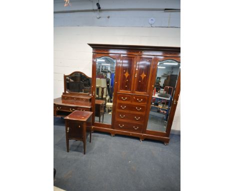 AN EDWARDIAN MAHOGANY THREE PIECE BEDROOM SUITE, comprising a compactum wardrobe with two bevelled mirror doors flanking doub