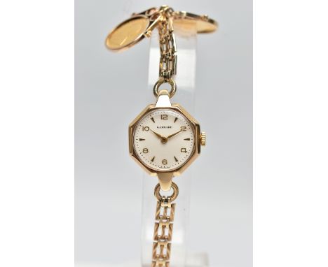 A GARRARD 9CT GOLD MANUAL WIND WRISTWATCH TOGETHER WITH TWO MOUNTED 1/10 OZ KRUGERRAND COINS, the watch with white dial, alte