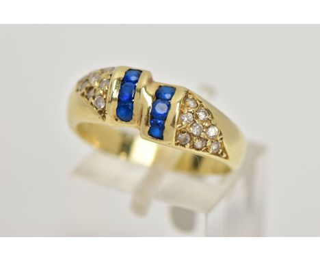 A YELLOW METAL GEM SET RING, designed with two asymmetrical rows of three circular cut synthetic blue spinels, flanked with r