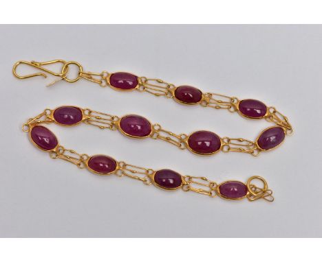 A YELLOW METAL AND RUBY SPECTACLE SET BRACELET, comprised of eleven slightly graduated oval cabochon rubies, each set in an o