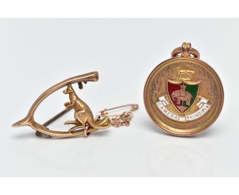 A 9CT GOLD FOB MEDAL AND A YELLOW METAL BROOCH, the fob medal of a circular form, detailed with a red and green enamel shield