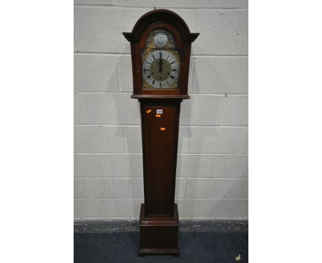 A 20TH CENTURY MAHOGANY CHIMING GRANDAUGHTER CLOCK, the arched door enclosing a brass and silvered 7 inch dial, Tempus Fugit 