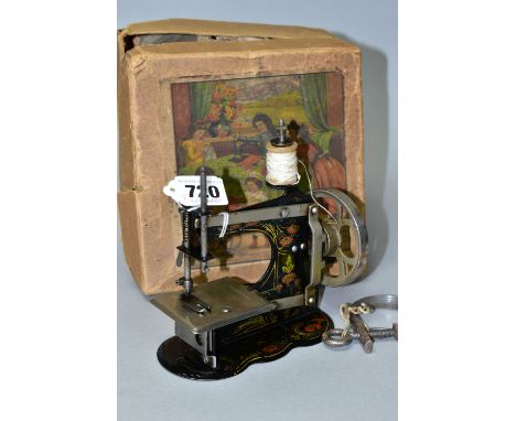 A VINTAGE GERMAN CHILDS SEWING MACHINE WITH BOX, appears to be complete and working, box tatty