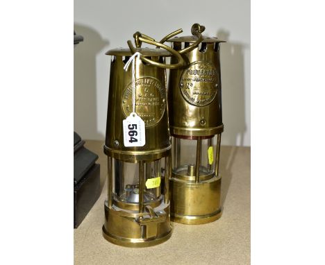 TWO BRASS MINER'S LAMPS, comprising a late 19th early 20th century brass Protector Lamp &amp; Lighting Co. Eccles, Manchester