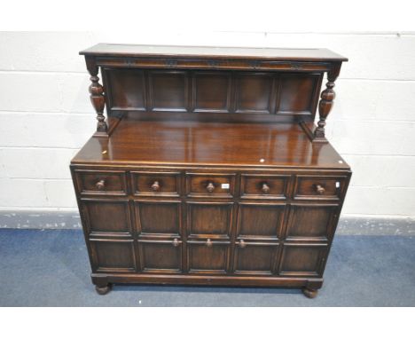 A 20TH CENTURY OAK SIDEBOARD/DRINKS CABINET, with raised back, base with three drawers above two cupboard doors, flanking a p