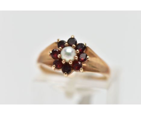 A 9CT GOLD CULTURED PEARL AND GARNET CLUSTER RING, the claw set cultured pearl, with circular cut garnet surround, to the tap