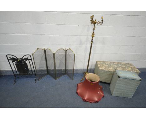 A WROUGHT IRON FIRESCREEN with a coat of arms within a shield, 49cm x 71cm, a brassed standard lamp, with woman supporting th