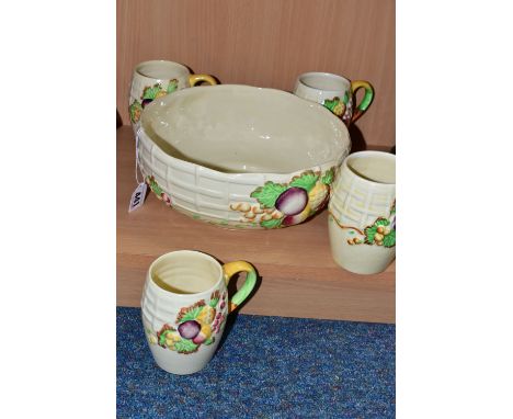 A CLARICE CLIFF 'FRUIT BASKET' FRUIT BOWL AND FOUR MUGS, with relief moulded fruits and basketweave pattern on a cream ground