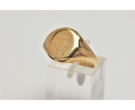 A 9CT GOLD SIGNET RING, oval signet with worn engraving, textured shoulders leading onto a tapering polished band, hallmarked