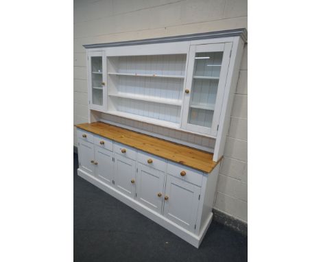 A LARGE PARTIALLY PAINTED AND PINE DRESSER, with an arrangement of shelves, cupboards and drawers, width 215cm x depth 45cm x