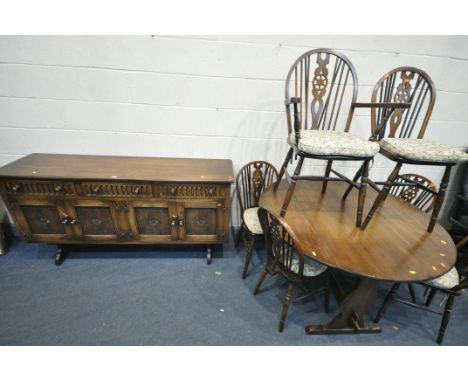 A 20TH CENTURY OAK CIRCULAR DROP LEAF TABLE, with trestle legs, united by a single stretcher, diameter 121cm x closed width 6