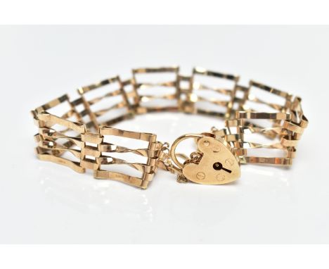 A 9CT GOLD GATE BRACELET, four bar polished yellow gold gate bracelet, fitted with a heart padlock and safety chain, approxim