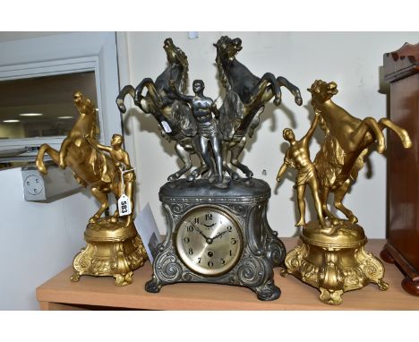 A FRENCH STYLE PEWTER CLOCK GARNITURE, the metal dial marked F.H.T with Arabic numerals, the case is surmounted with two rear