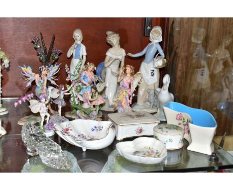 A GROUP OF ORNAMENTS AND GIFTWARES, to include a Nao figurine of a girl with a puppy, a Nao duck, two similar figurines, a gl