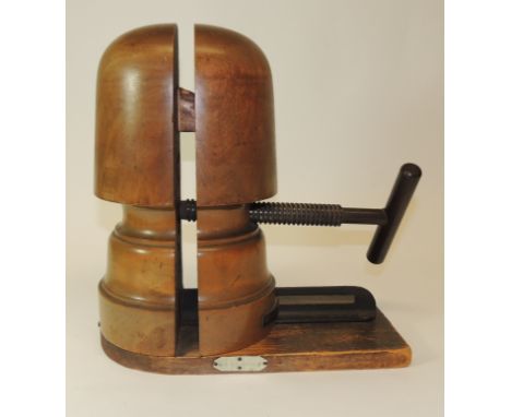 A late 19th/early 20th Century hat stretcher, shaped beechwood with side mounted iron screw, the wood base with ivorine scale