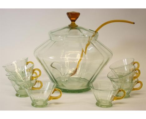 An Art Deco green and amber glass punch bowl set.  Of geometric form.  Comprising of punch bowl with lid, punch ladle and ten