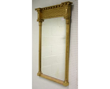 A Georgian gilt console mirror of rectangular design having lattice top panel, reeded columns flanking the plate, overall 94c