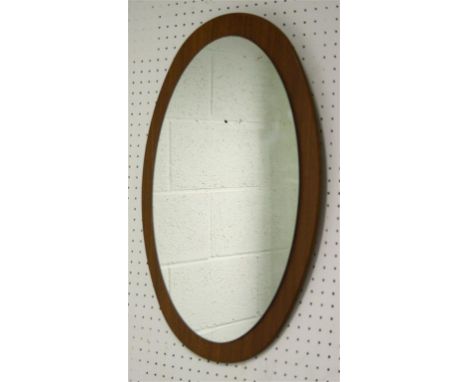 A 1960's oval teak-backed wall mirror.  57 cm high, 37 cm wide.  