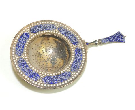 A Norwegian enamelled silver tea strainer, maker ECK, .925 and with Birmingham import marks 1905, 12cms long to end of handle