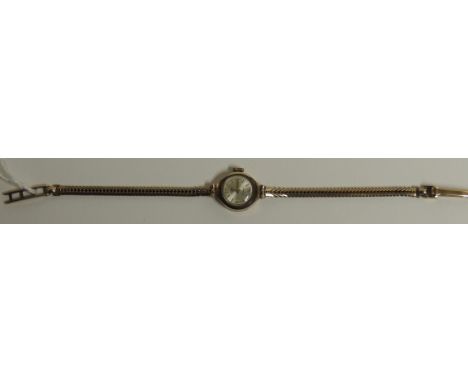 A ladies 9ct gold "ROTARY" wristwatch, manual wind, with integral 9ct gold sinuous strap.  The silvered dial with gilt Arabic